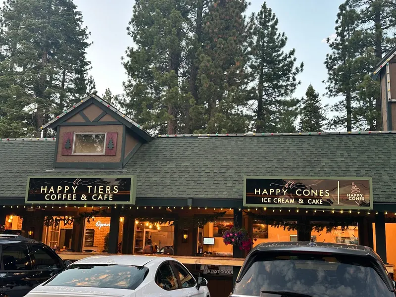 The Happy Tiers Coffee and Cafe storefront with a green roof.