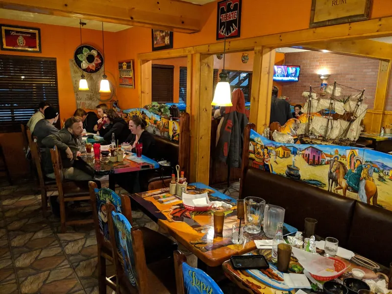 Diners at colorful painted booths and tables.