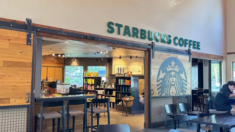 The coffee counter and seating area inside the Starbucks.