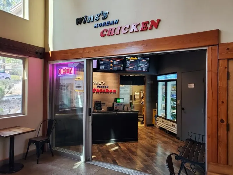 The Wing's Korean Chicken counter with a lit open sign.