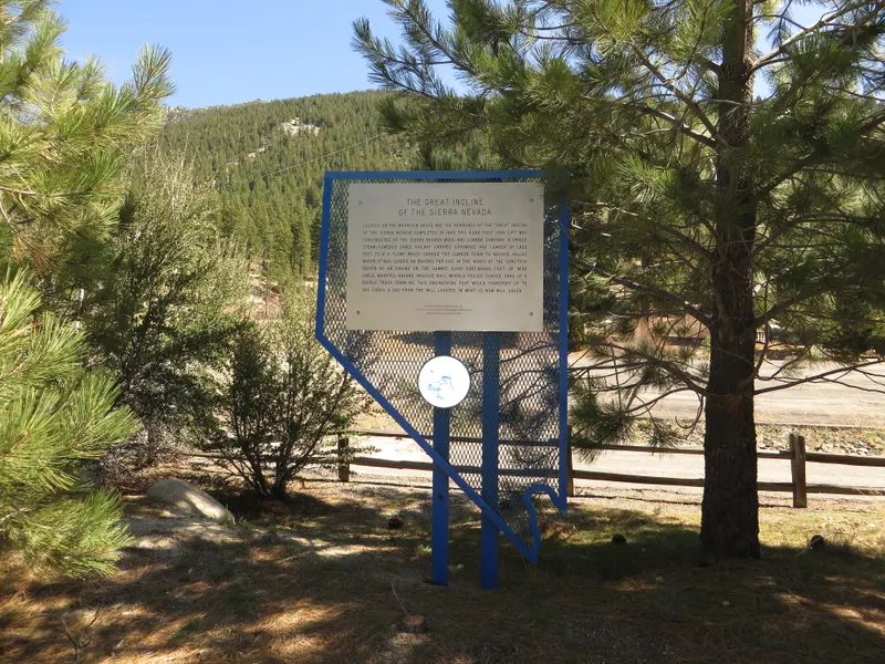 The Great Incline of the Sierra Nevada historical marker (No. 246) among pines in Incline Village.
