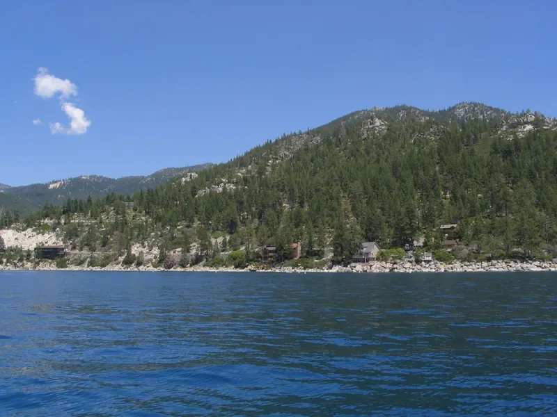 A forested headland above deep blue water on the north shore of Lake Tahoe near Incline Village.