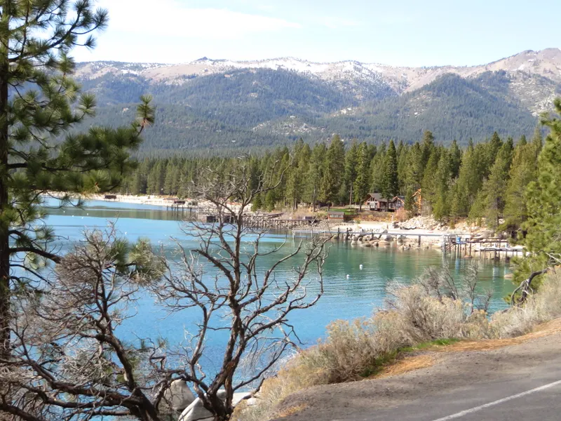 A cove on the north shore of Lake Tahoe near Incline Village, with docks and snowy mountains behind.