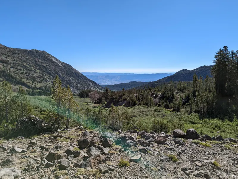 Rocky trail and open slopes on the Mt. Rose Trail with a view toward the valley.